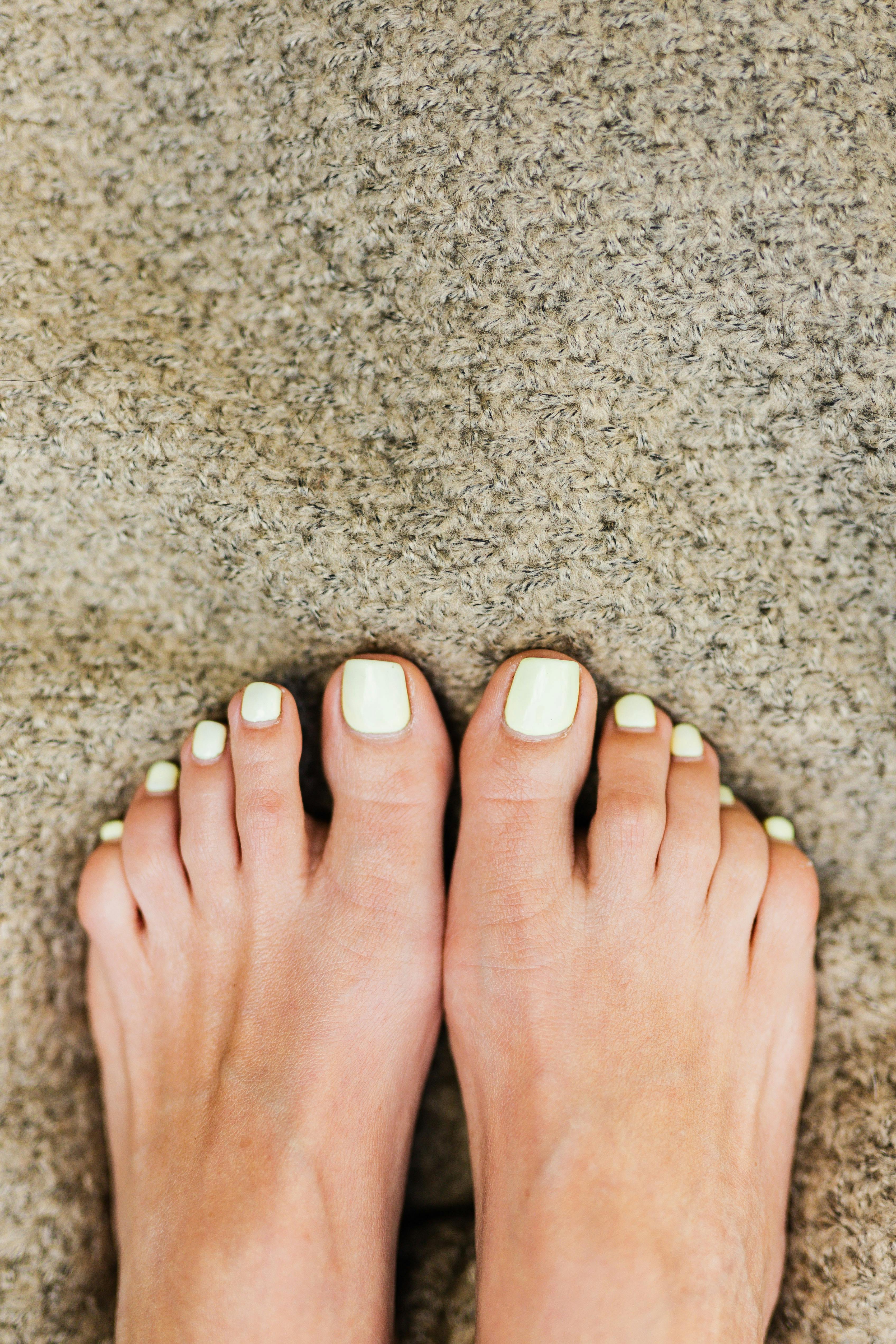Healthy natural female feet with a clean neutral polish